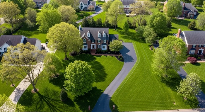 Aerial view of freshly sealed asphalt driveway showing precision application